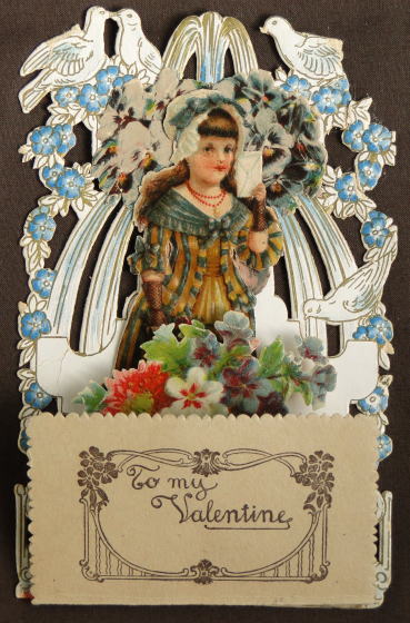 アンティーク雑貨＞アンティーク・カード＞ヴィクトリアン・ポップアップカード＞To my Valentine　鳩と花に囲まれた少女が左手に封筒を持っています。